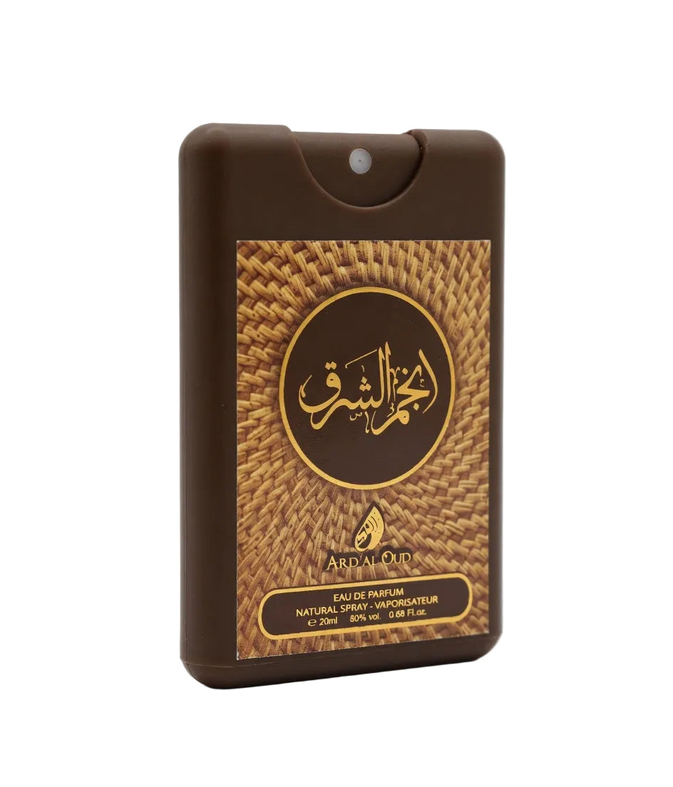 A brown rectangular perfume atomizer bottle with a gold and brown woven-pattern label featuring Arabic calligraphy and the brand name Anjam al Sharq 20ml EDP travel size oud perfume