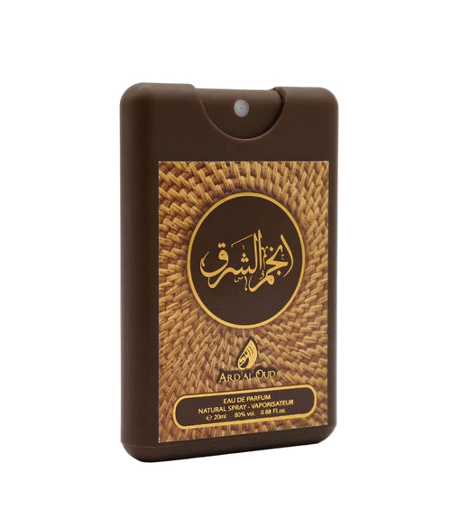 A brown rectangular perfume atomizer bottle with a gold and brown woven-pattern label featuring Arabic calligraphy and the brand name Anjam al Sharq 20ml EDP travel size oud perfume