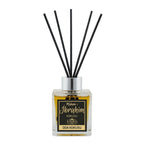 A reed diffuser bottle with a clear glass container filled with amber liquid, a silver cap, and five black reeds. The front label reads 'Mokom-1 Ibrahim KOKUSU ODA KOKUSU' with a black and gold design.