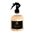 A 500ml clear spray bottle of Anar Breeze Velvet Oud Air Freshener, filled with a light amber liquid and topped with a black trigger sprayer and black label.